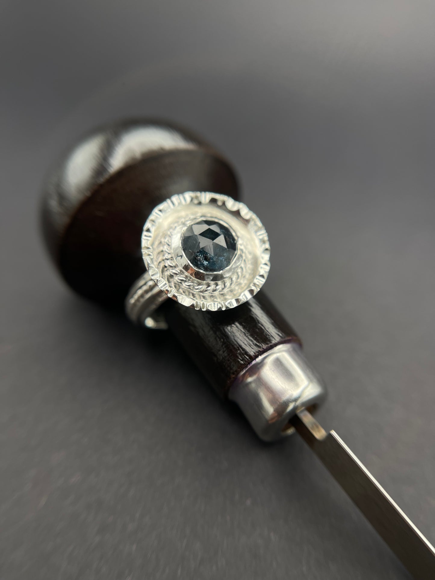 Kyanite Sterling Silver Statement Ring with a graver in the background as a prop